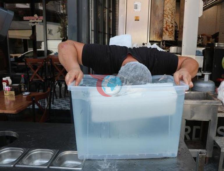 Adana’da sıcakla mücadelede ilginç yöntem Döner ustası vücuduna kalıp buz bağladı
