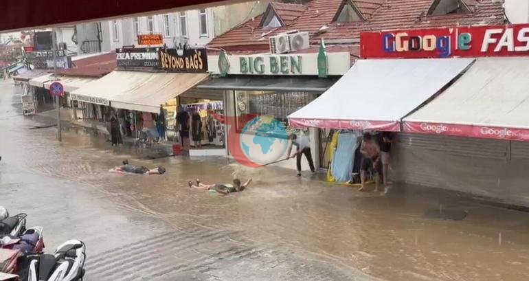 Astonishing image after the downpour in Fethiye Tourists swam with inflatable beds in flood waters